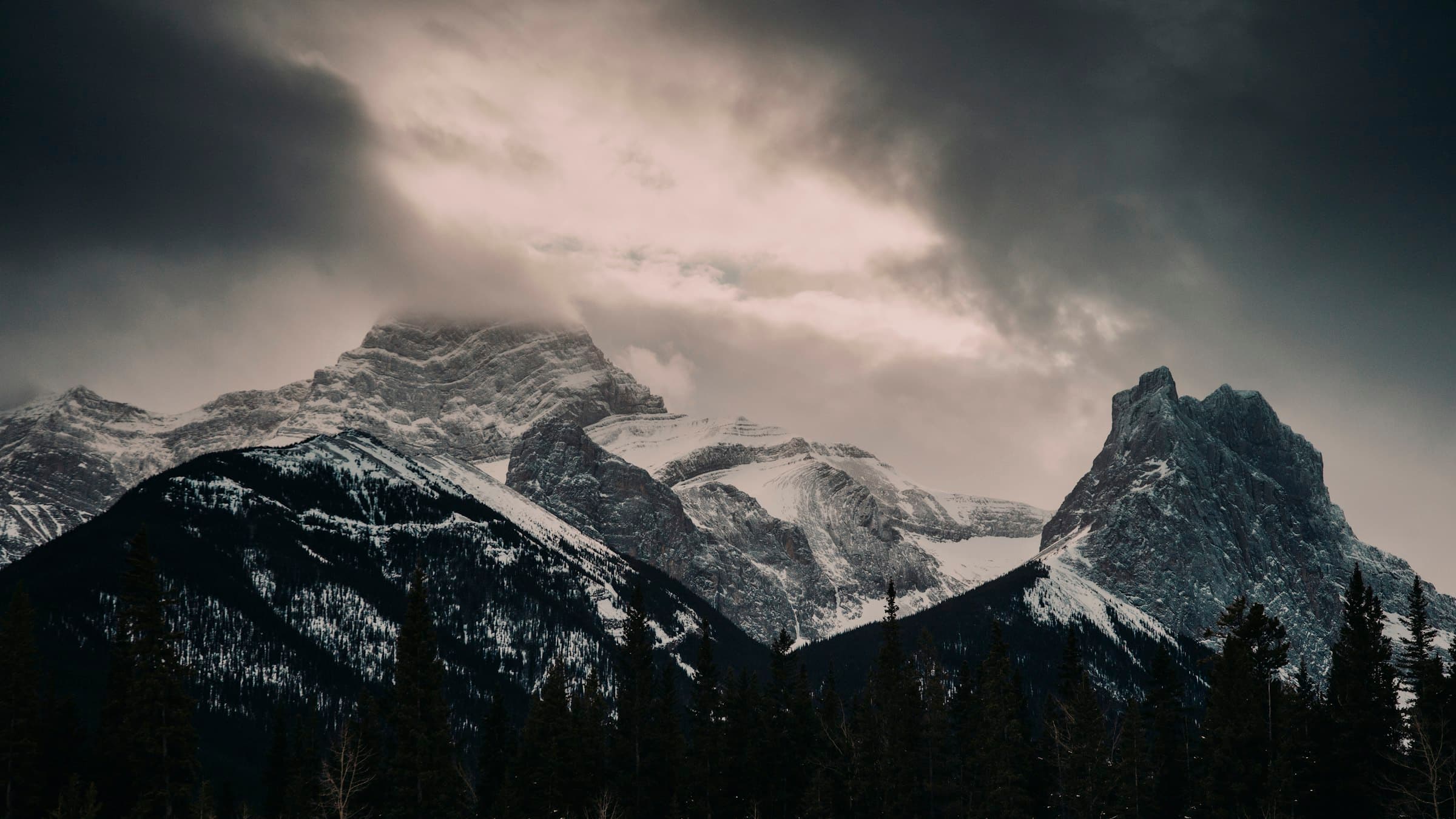 The Three Sisters in the front range under brooding cloud, an hour west of the room